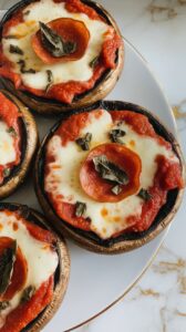 grilled portobello mushroom pizzas fresh off the grill, sprinkled with chopped basil and ready to serve