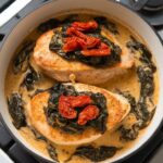 golden seared chicken breasts nestled into the creamy Tuscan sauce, topped with wilted spinach and sun-dried tomatoes.