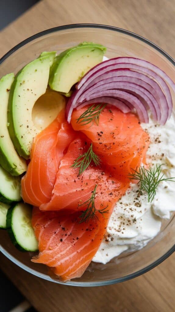 inished toppings: capers, fresh dill, cracked black pepper, and a lemon wedge on the edge of the bowl.