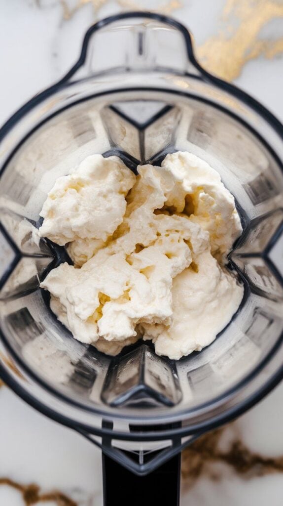 ow-fat cottage cheese in a blender cup, showing curds and creamy texture before blending.
