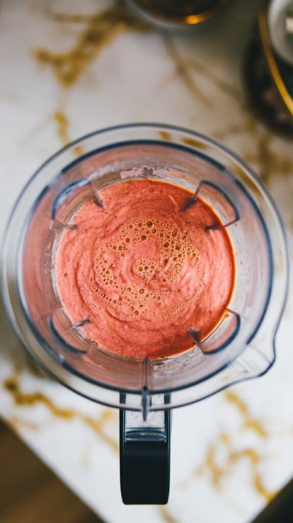 blended rhubarb gazpacho in a blender, pale green-pink in color, smooth and creamy with no chunks